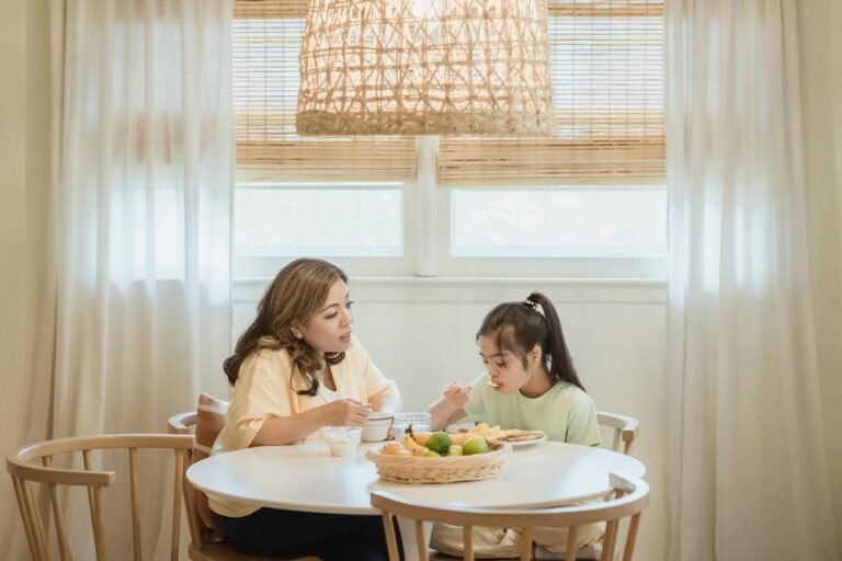 Mother daughter eathing breakfast together